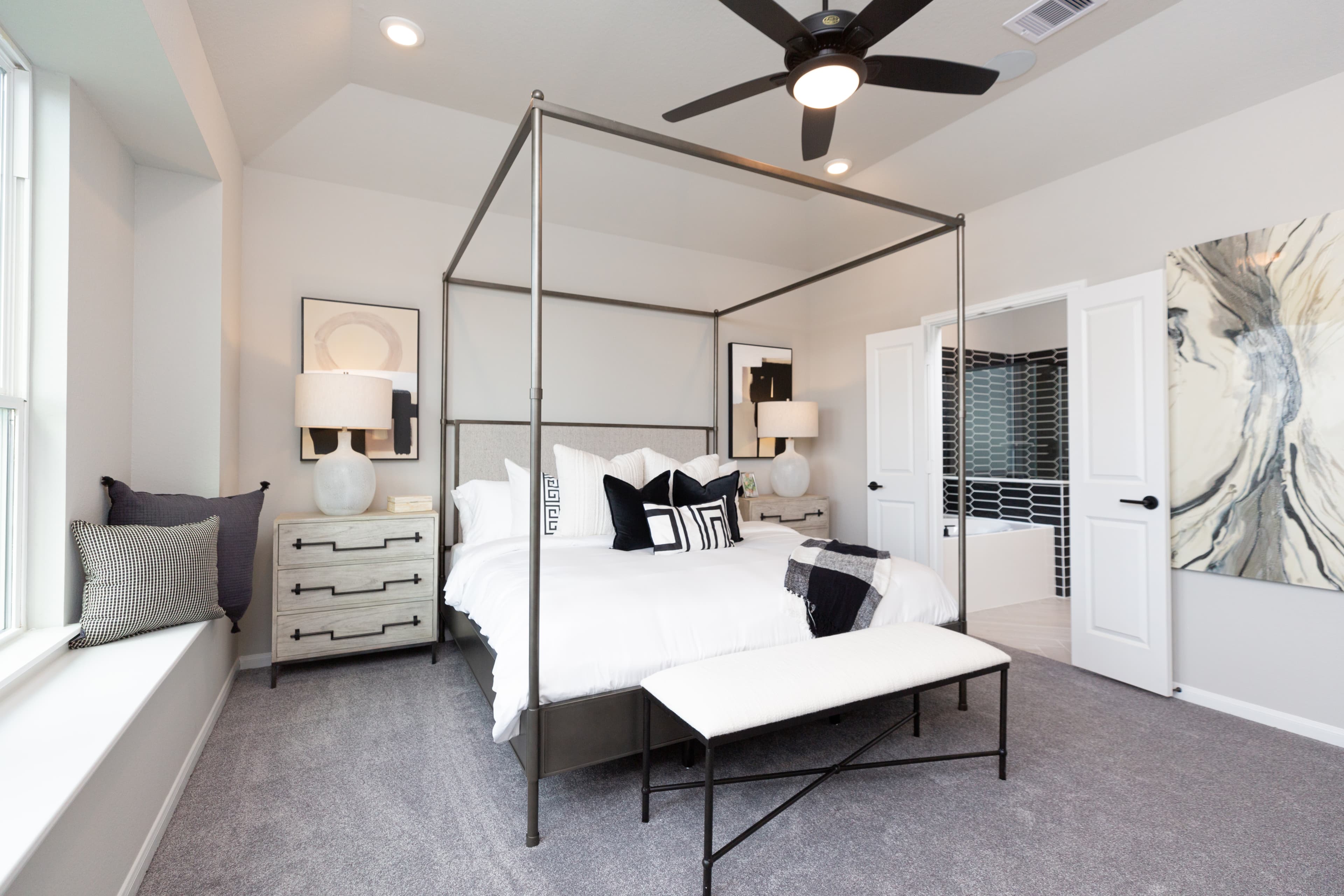 bedroom with ceiling fan and window seat