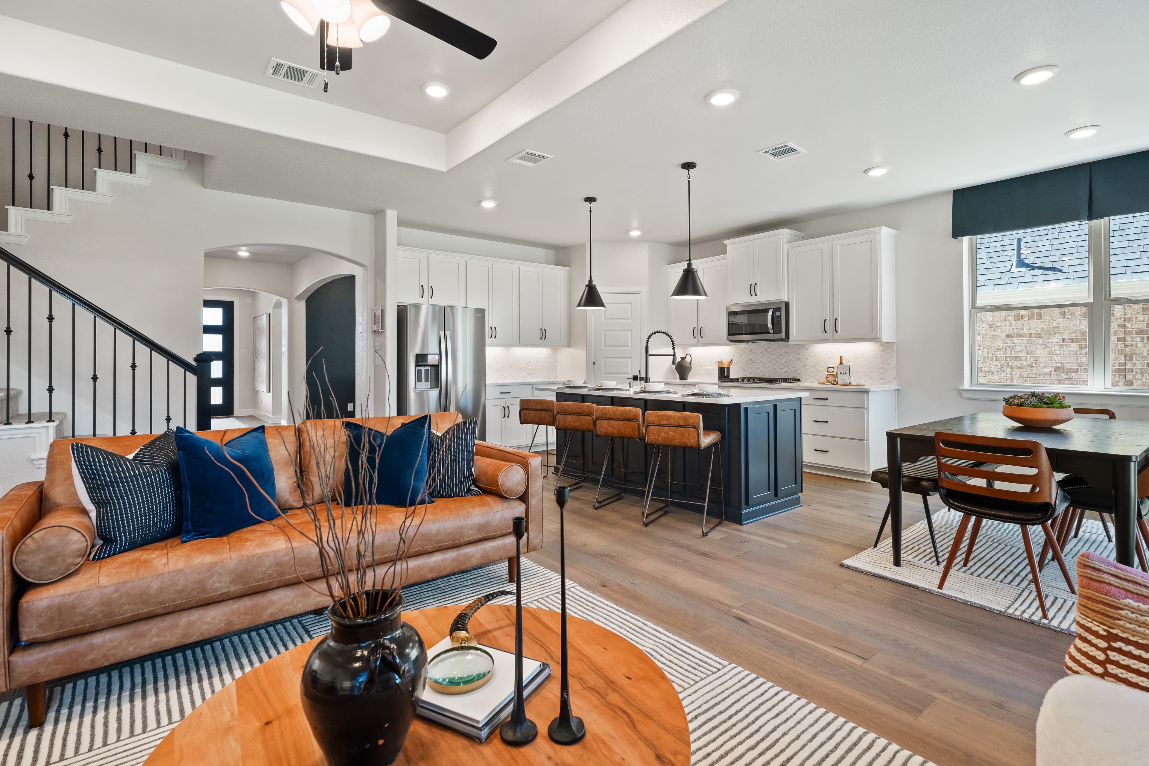 open great room with wood floors and ceiling fan