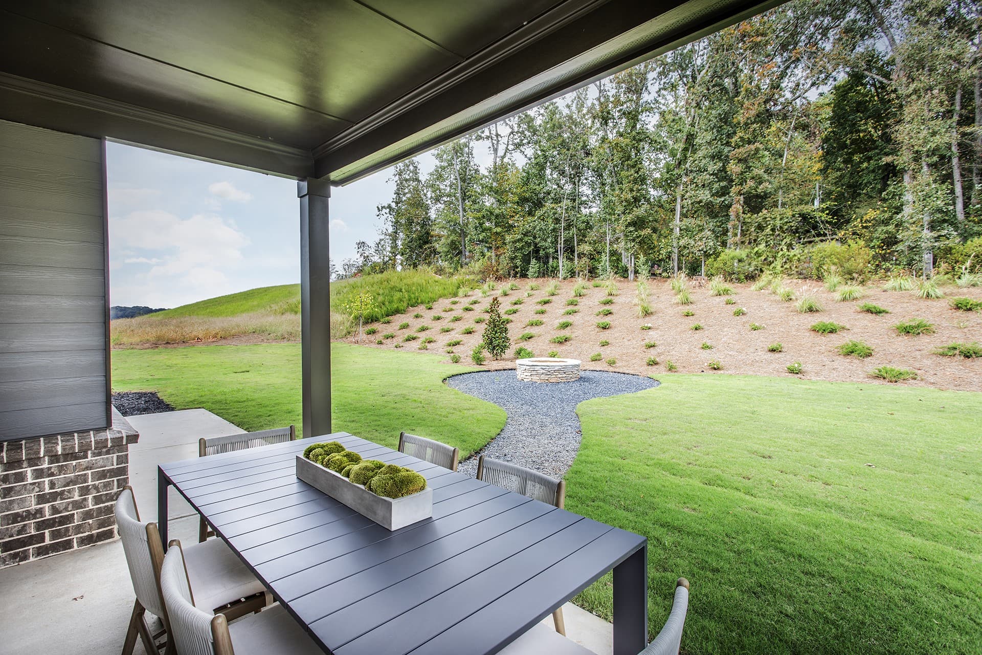 backyard with outdoor fireplace & patio table