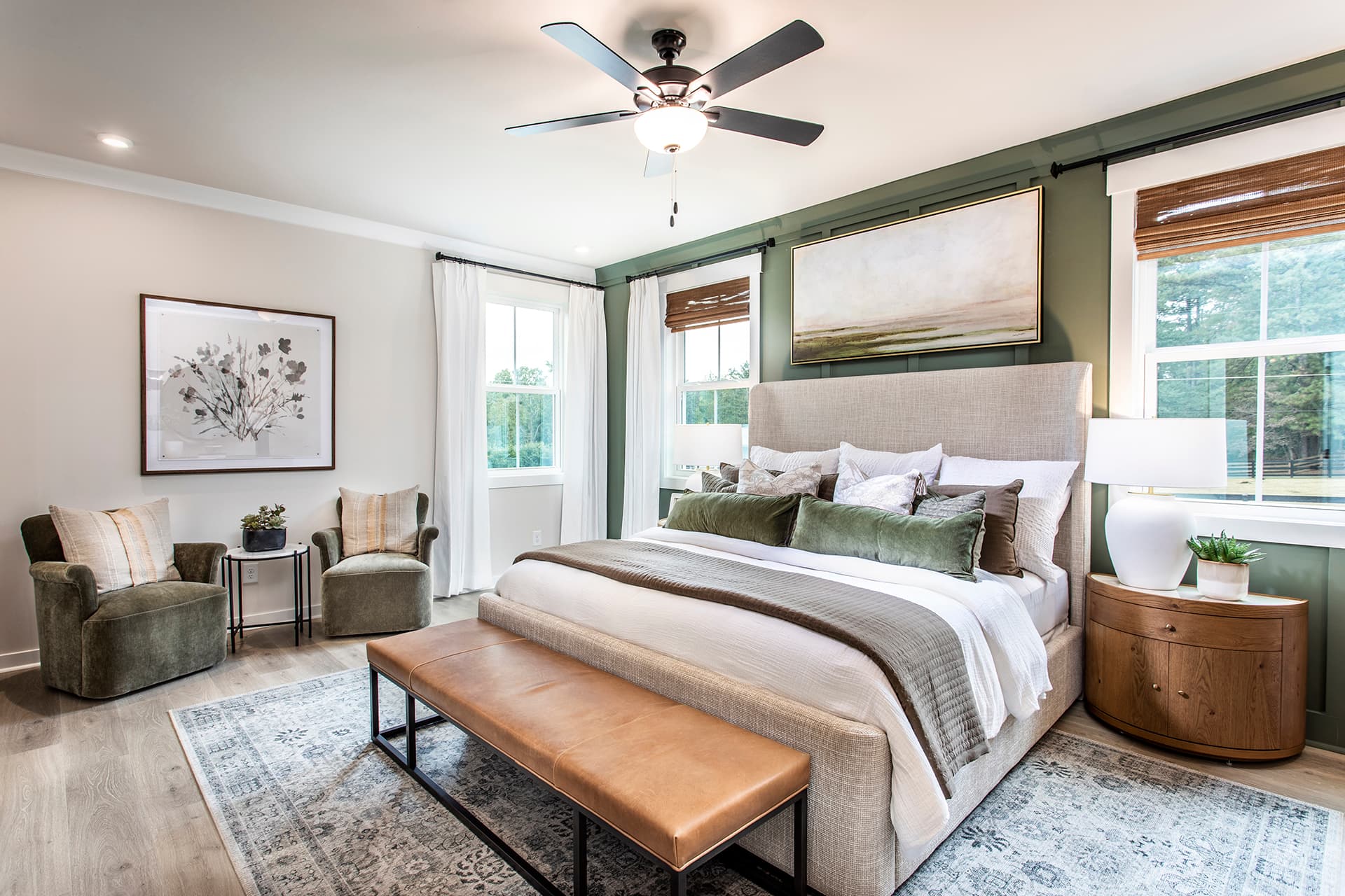 primary bedroom with king bed and plank flooring