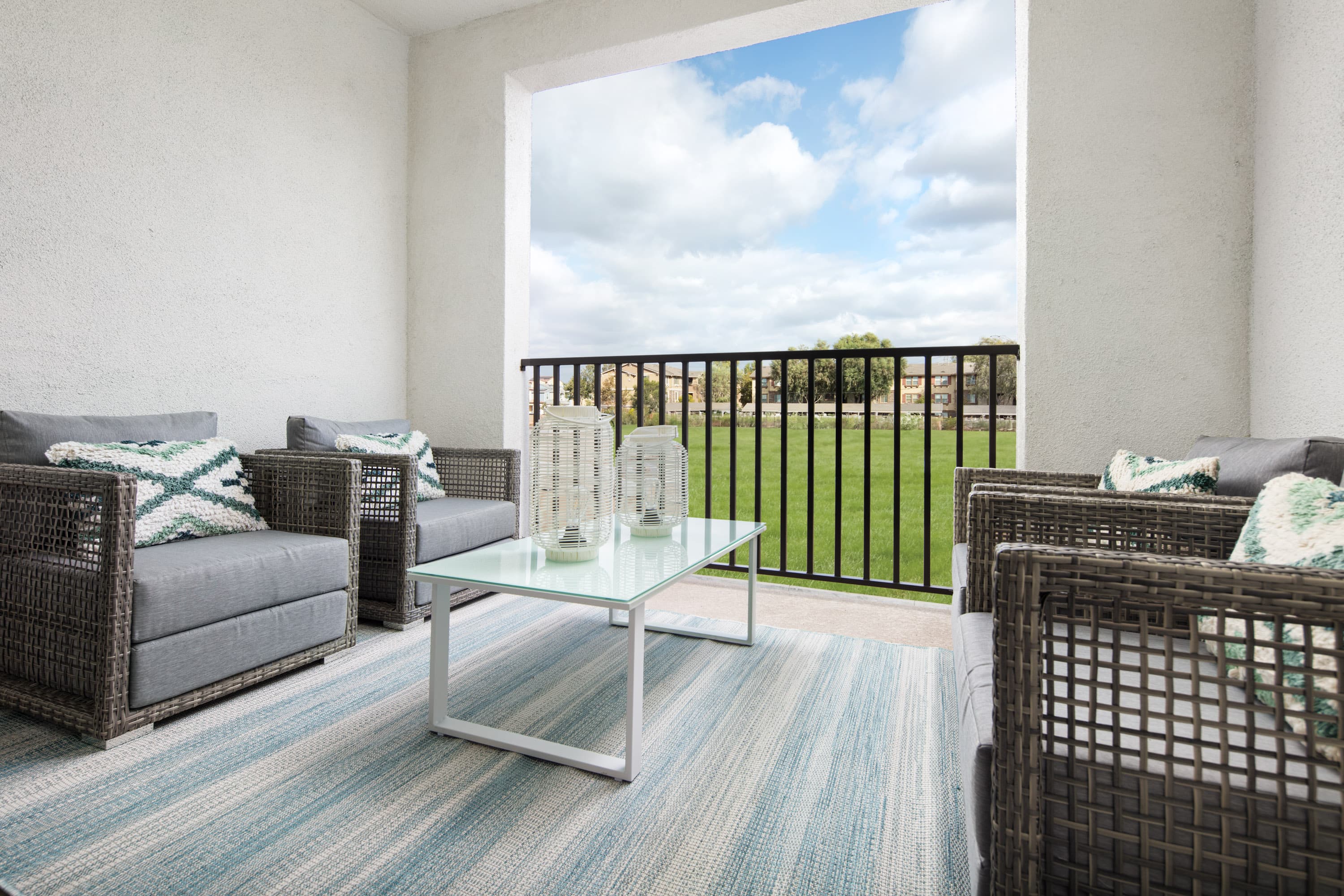 patio area that has two couches and an area rug