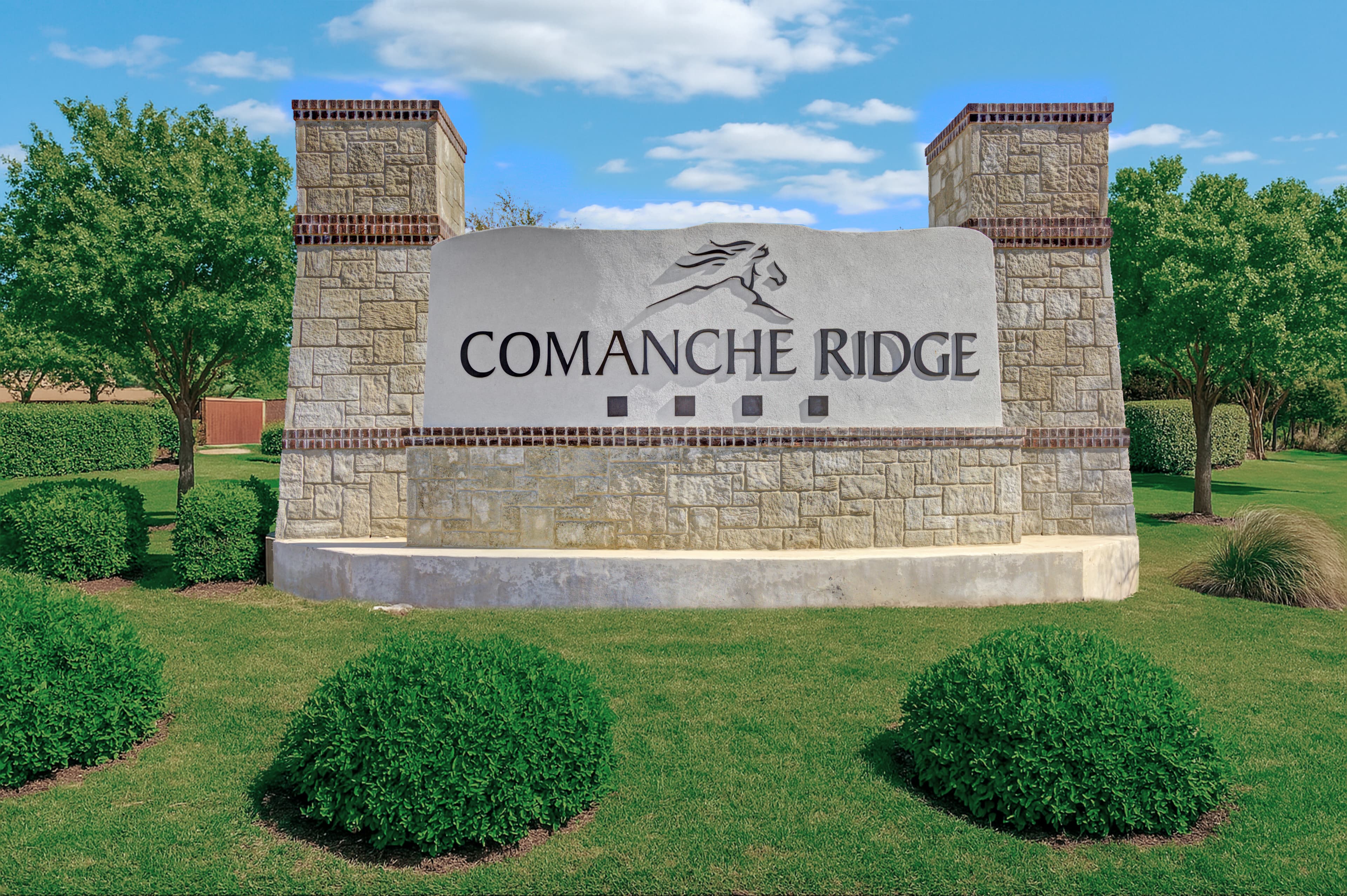 monument with large stone sign & rocks