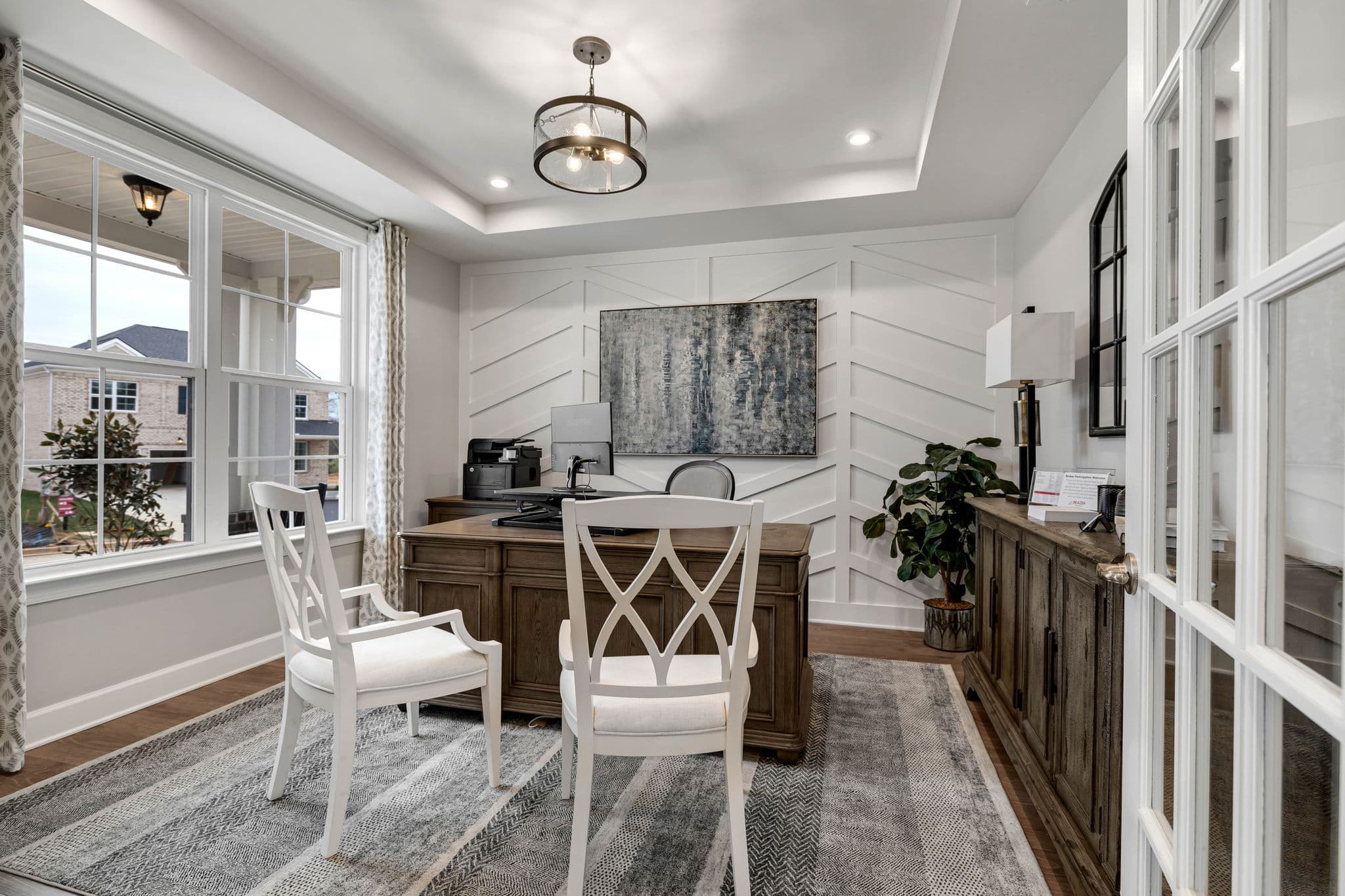 study with desk, chairs, and accent wall