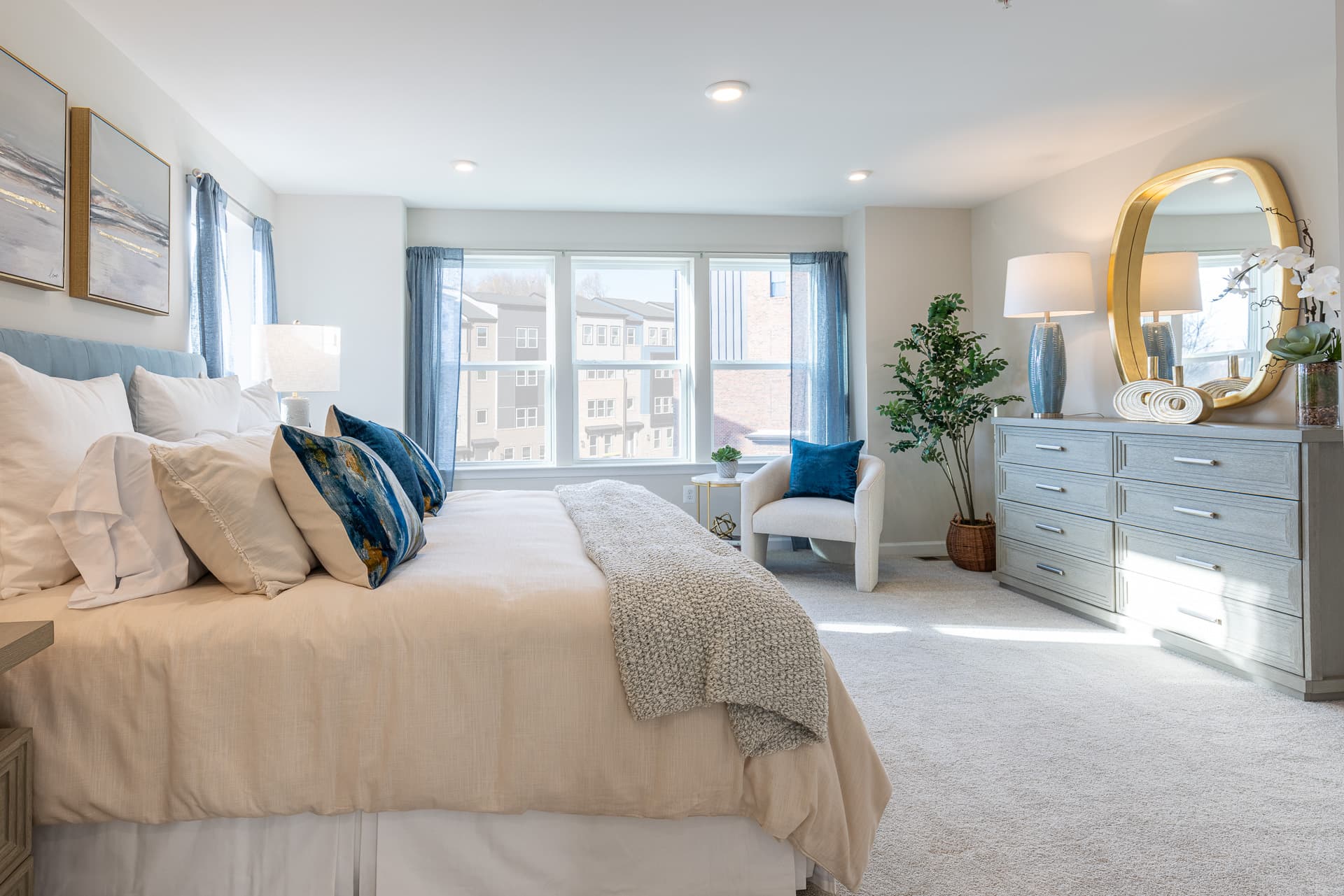 primary suite with a king bed and large windows