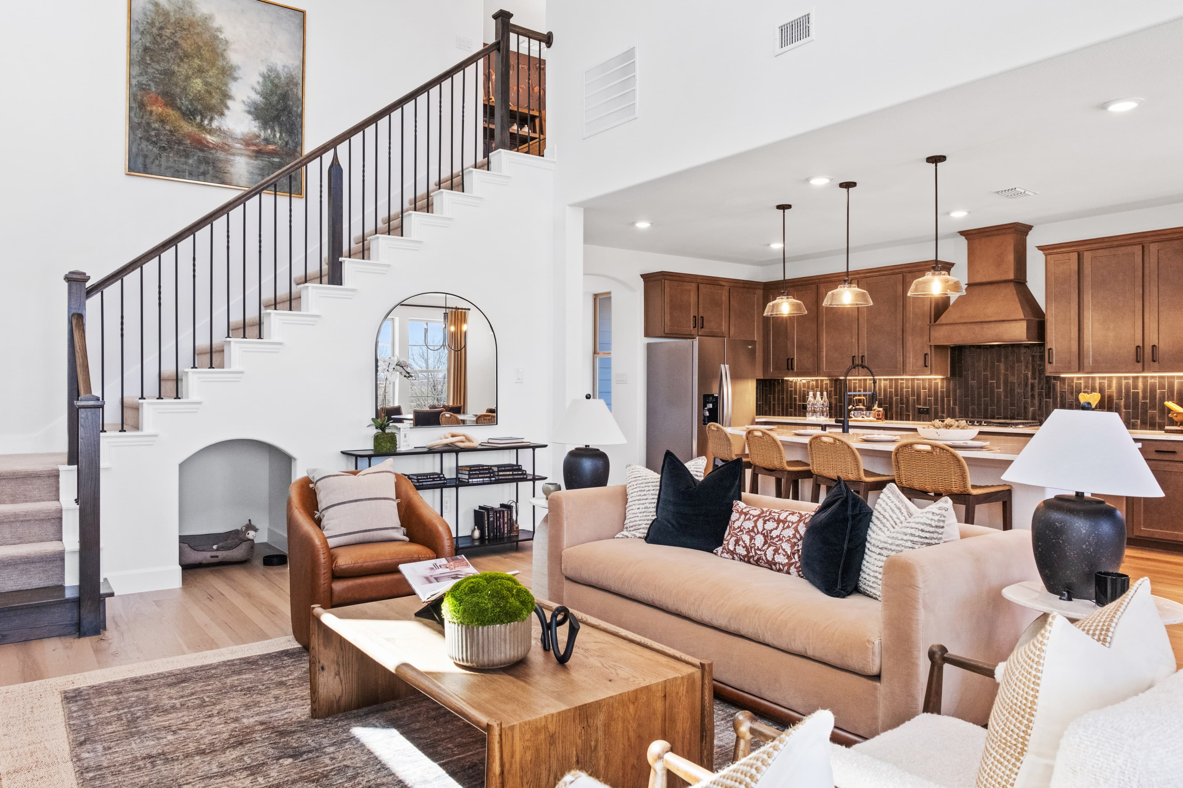 great room with wood floors and soaring ceilings 