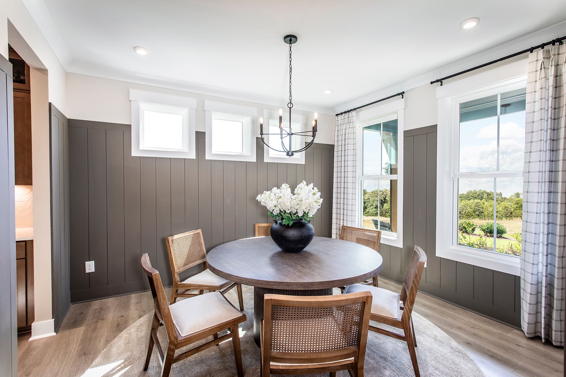dining room with large windows and plank flooring