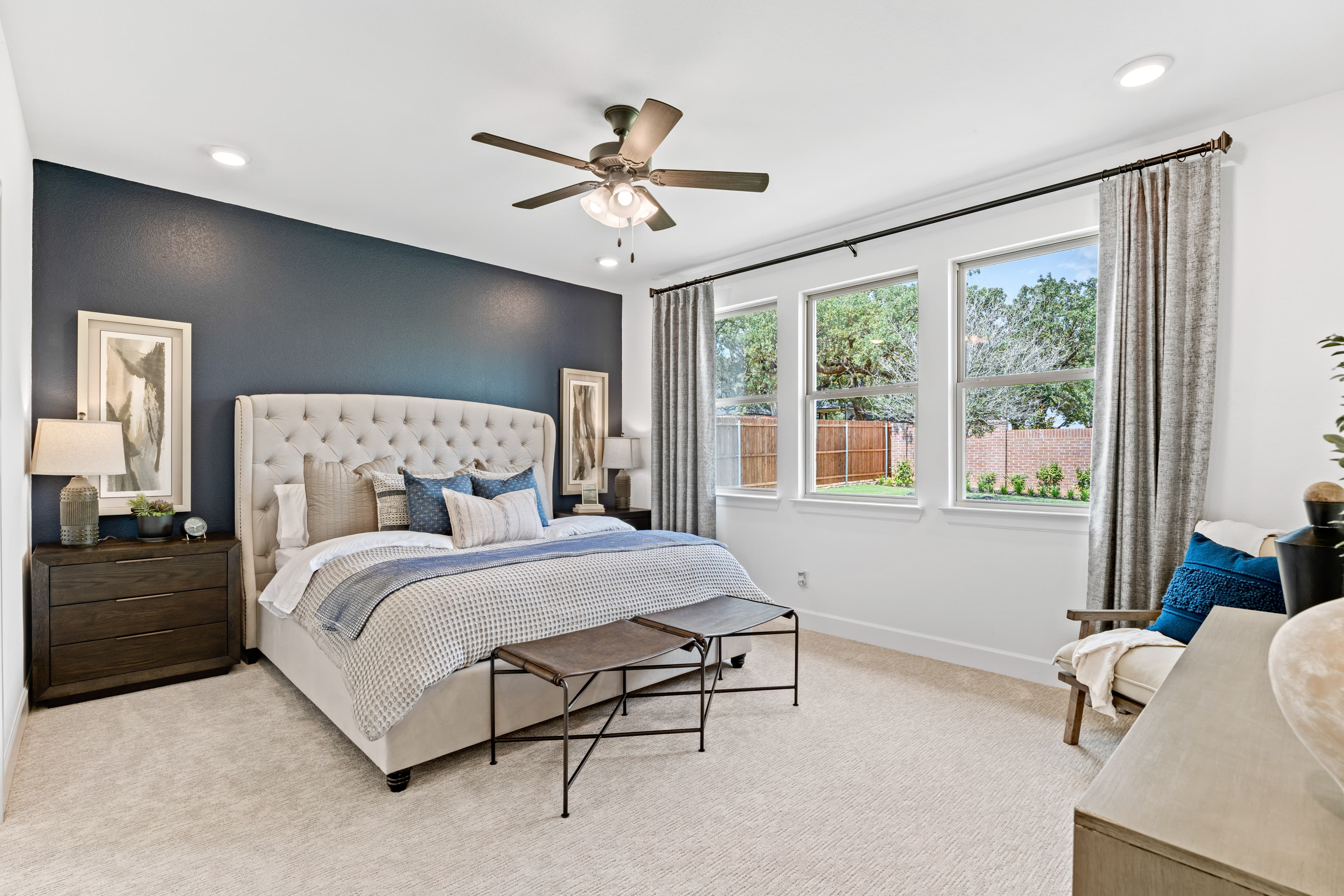 primary bedroom with carpet and windows