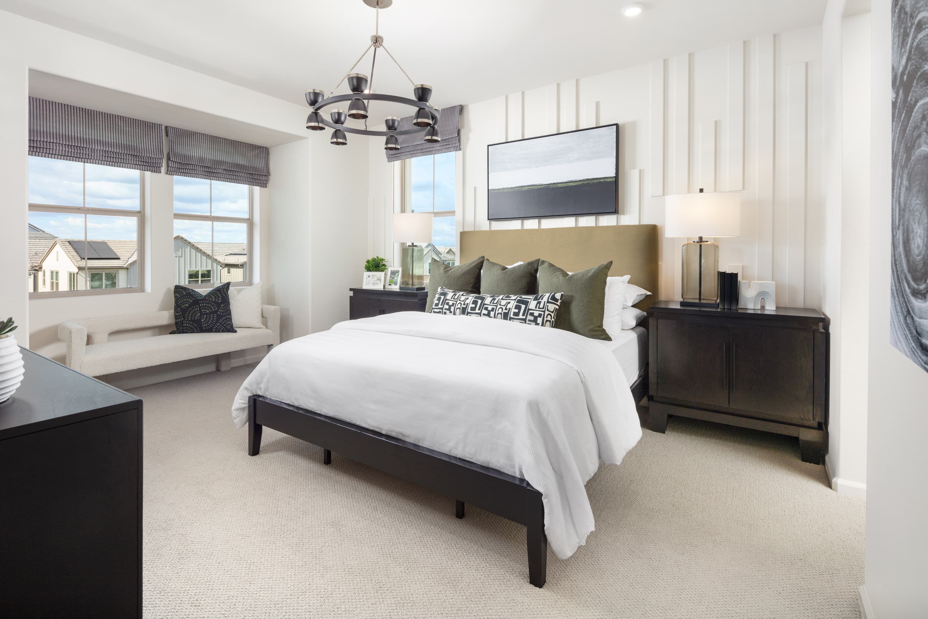 bedroom with king-sized bed and a bench area