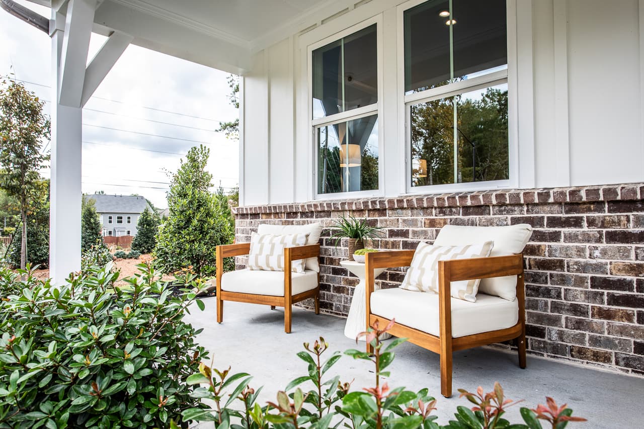 front porch with outdoor furniture & brick detail
