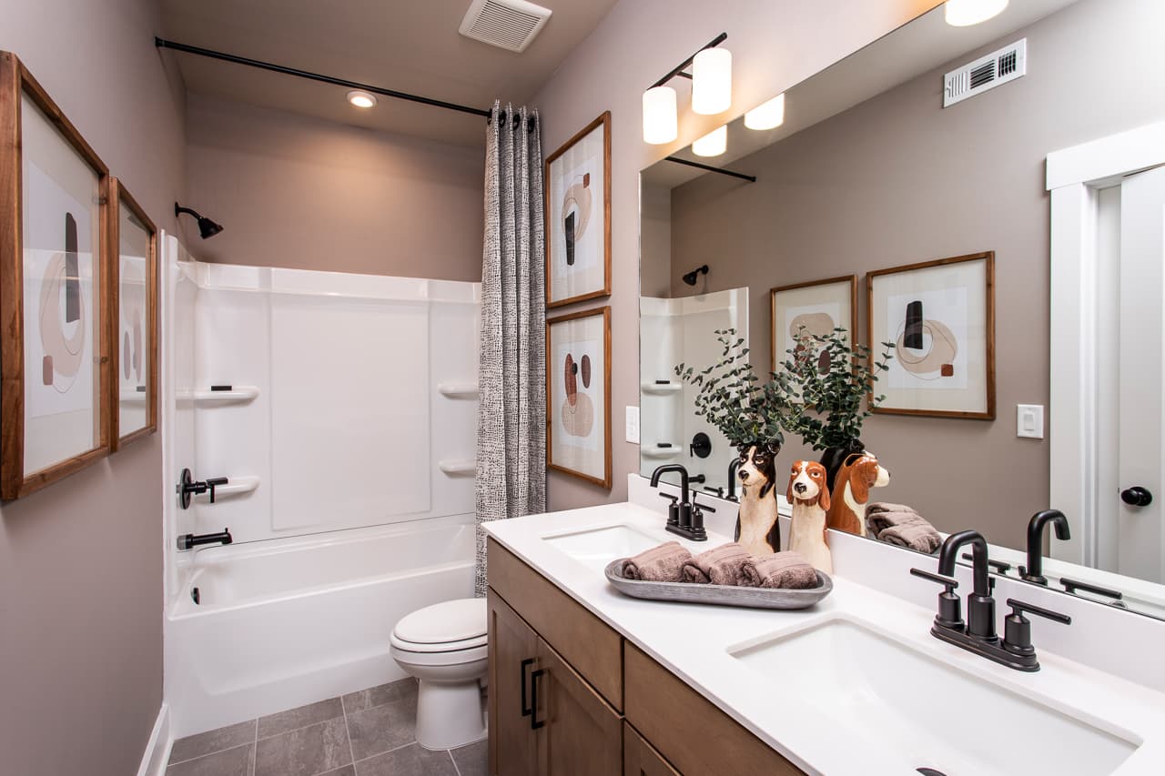 secondary bathroom with wood-finish cabinets 
