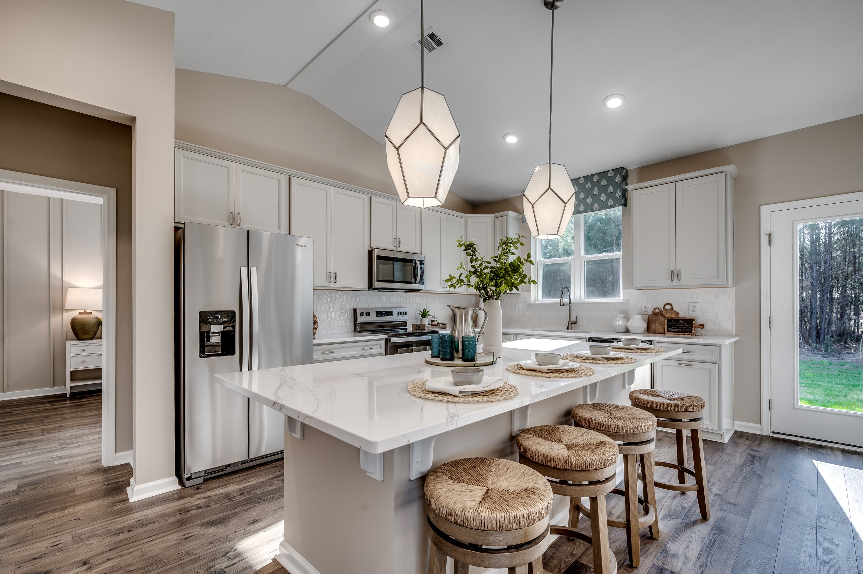 spacious kitchen with white cabinets 