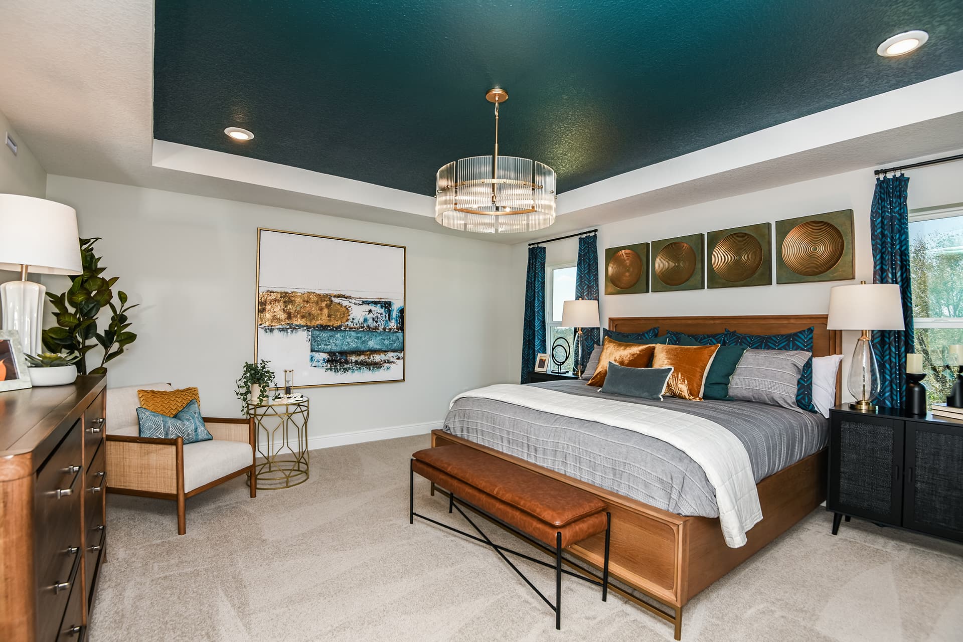 primary bedroom with bed and painted tray ceiling
