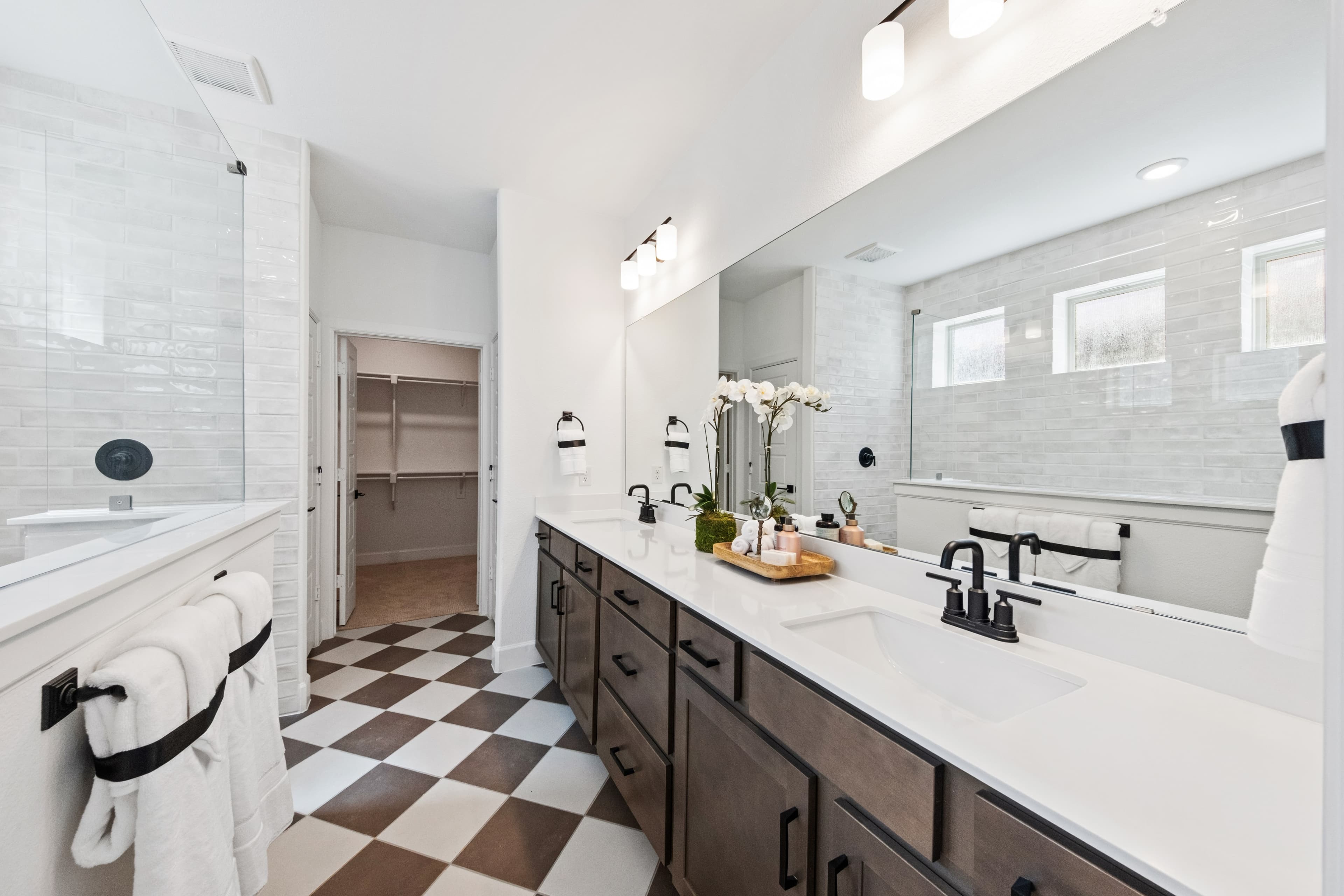 primary bathroom with two sinks and tile floor