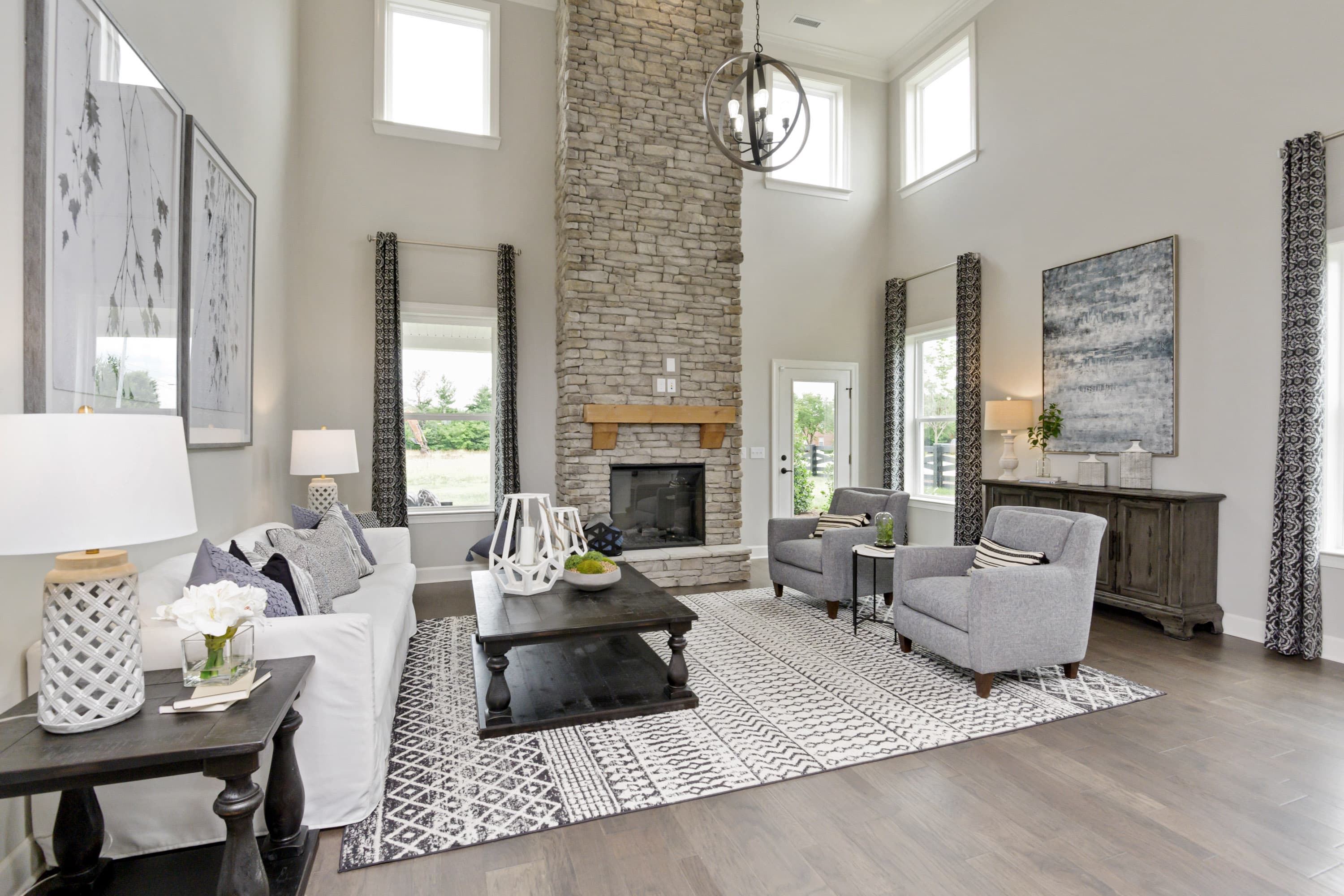 great room with floor to ceiling stone fireplace