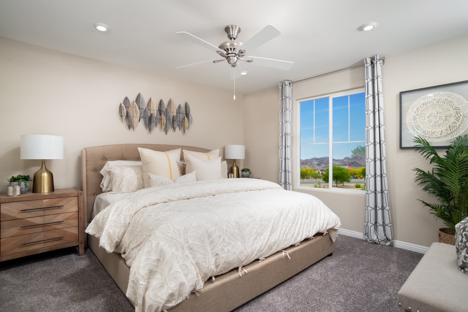 primary bedroom with ceiling fan and window